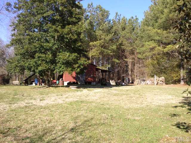 1421 Sykes Road Spring Hope, NC 27882 - Photo 3 of 11 a view of a yard with a house and trees
