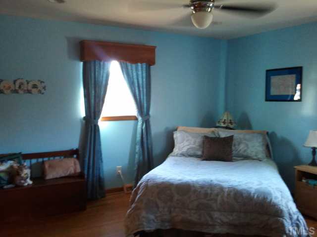 1421 Sykes Road Spring Hope, NC 27882 - Photo 4 of 11 a bedroom with a bed and window