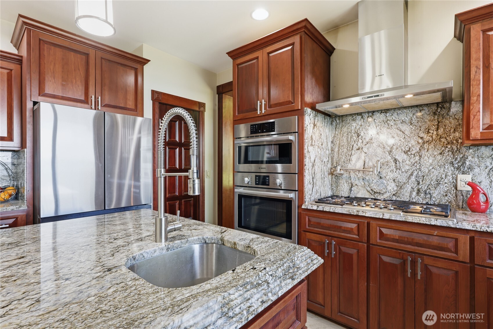1411 Thorndyke Road Port Ludlow, WA 98365 - Photo 16 of 40 a kitchen with stainless steel appliances granite countertop a sink stove and cabinets
