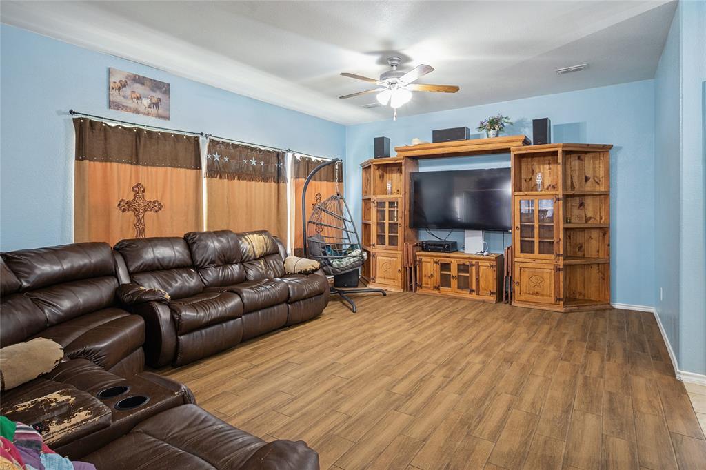 324 Fairgrounds Lane Ponder, TX 76259 - Photo 4 of 40 a living room with furniture and a flat screen tv