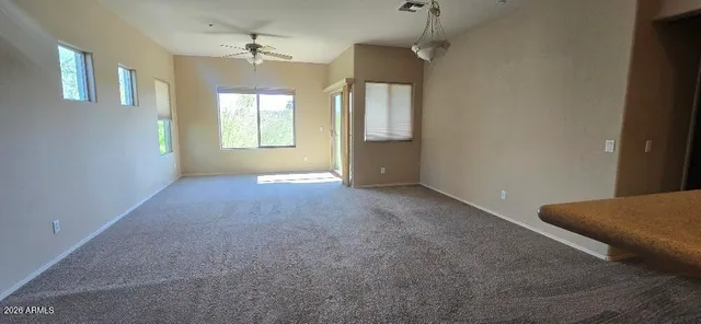 an empty room with windows and closet