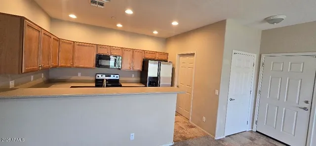 a kitchen that has a sink and a refrigerator