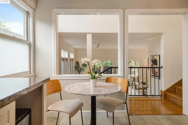 a view of a dining room with furniture and a potted plant