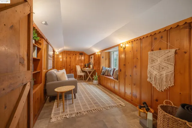 a living room with furniture and a painting on the wall