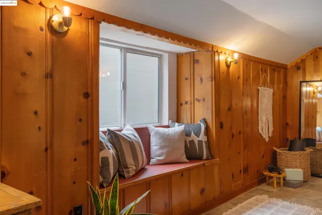 a blue bed sitting in a bathroom next to a window