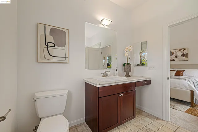 a bathroom with a toilet a sink and mirror