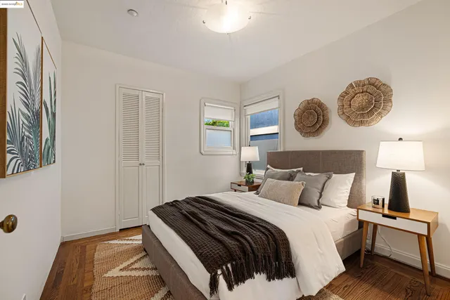 a bedroom with a bed and painting on the wall