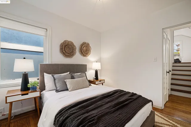 a bedroom with a bed and a lamp on table