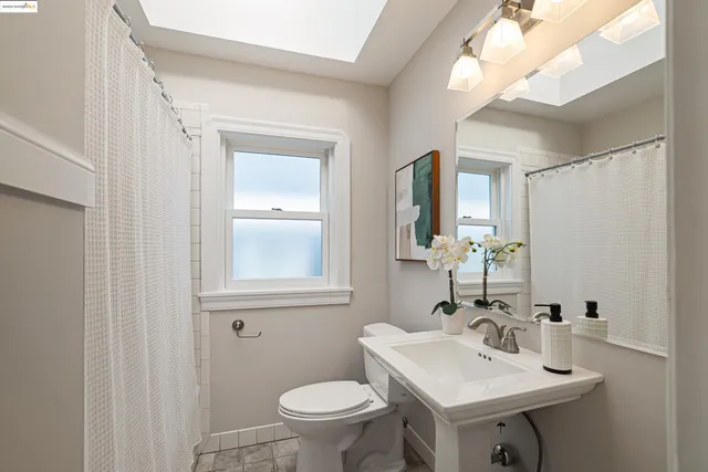 a bathroom with a toilet sink and mirror