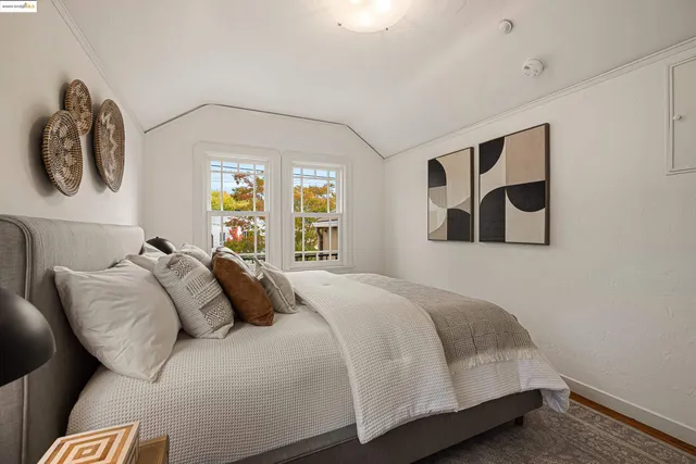 a bedroom with a bed and a painting on the wall