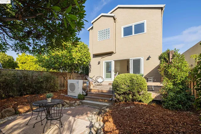 a view of a patio with table and chairs and potted plants
