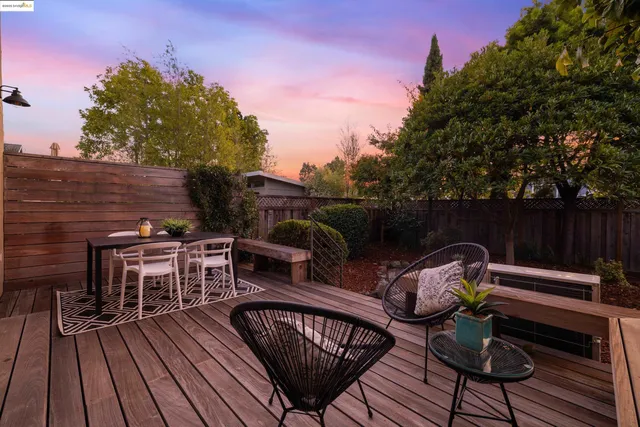a view of a roof deck with wooden floor and outdoor seating