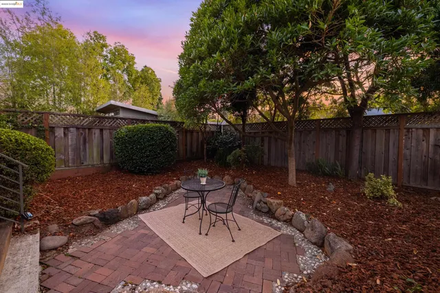 a view of a backyard with furniture and a cabin