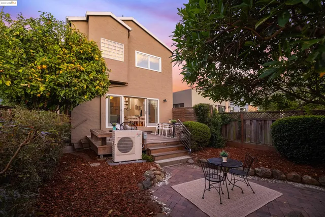 a view of a house with backyard sitting area and garden