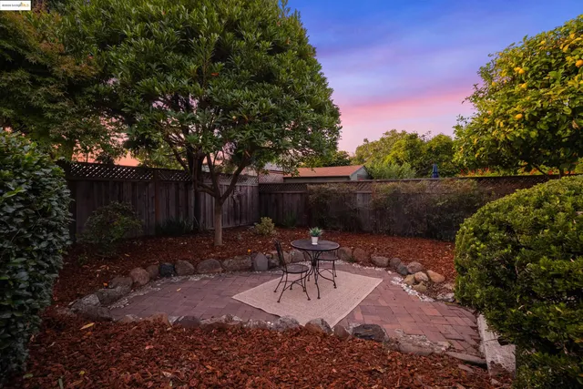 a view of a backyard with furniture and a slide