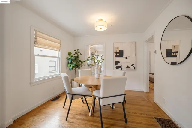 a view of a livingroom with furniture mirror and wooden floor