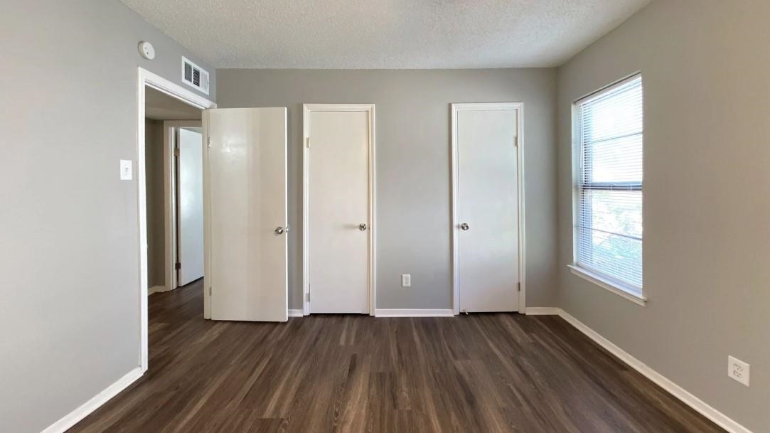 4326 Cloudburst Road Memphis, TN 38141 - Photo 2 of 10 Unfurnished bedroom featuring dark hardwood / wood-style flooring and a textured ceiling