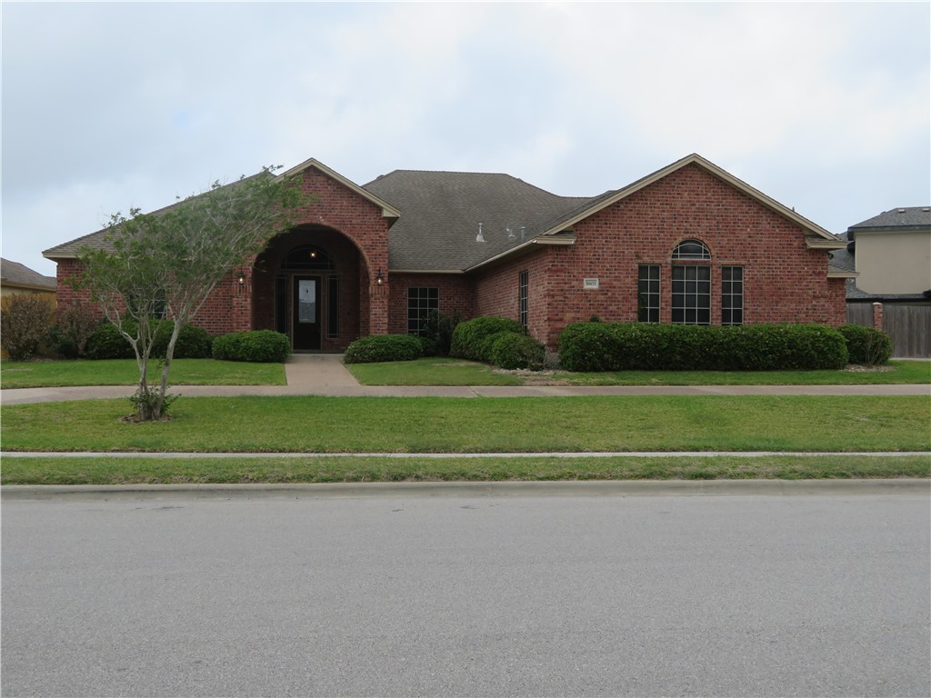 5803 South Oso Parkway Corpus Christi, TX 78414 - Photo 1 of 39 a front view of a house with a yard and a garage