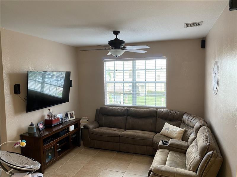 4222 Southwest 132nd Avenue Miramar, FL 33027 - Photo 4 of 11 a living room with furniture and a flat screen tv