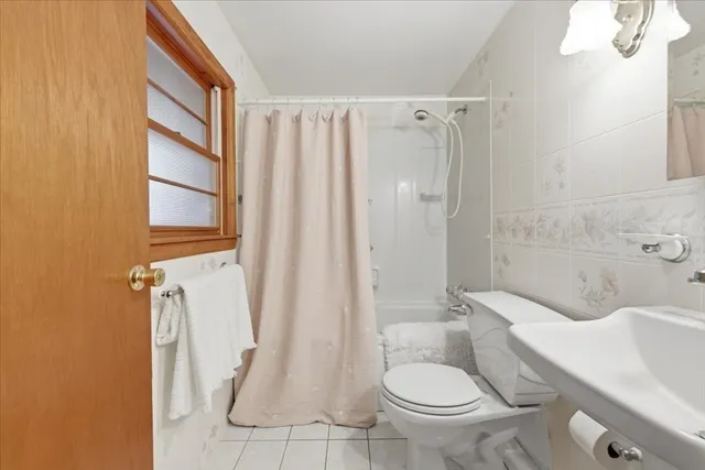 a bathroom with a toilet sink and shower