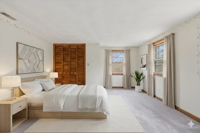 a bedroom with a large bed and a window