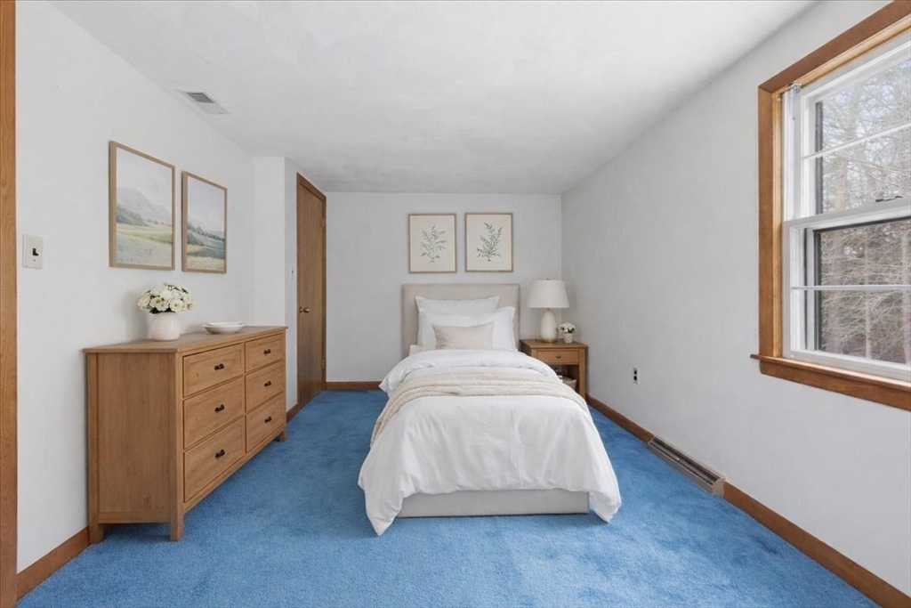 107 Oak Street Pembroke, MA 02359 - Photo 24 of 38 a spacious bedroom with a bed and a window