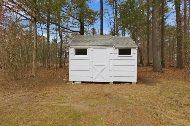 a view of a house with a large tree