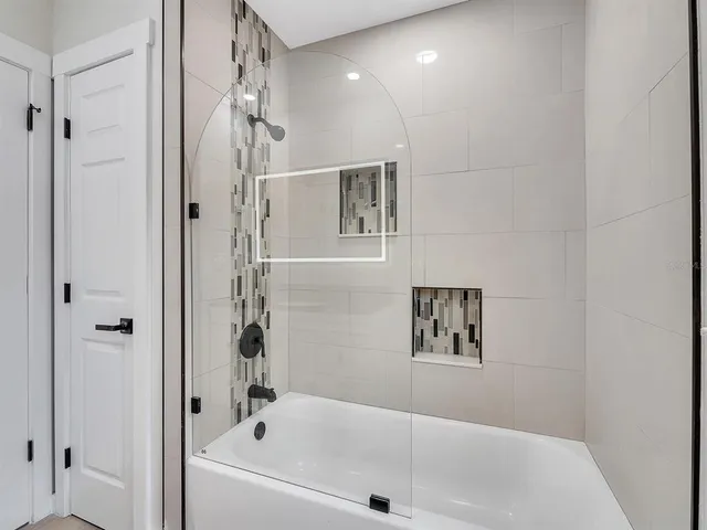 a bathroom with a bathtub and a shower