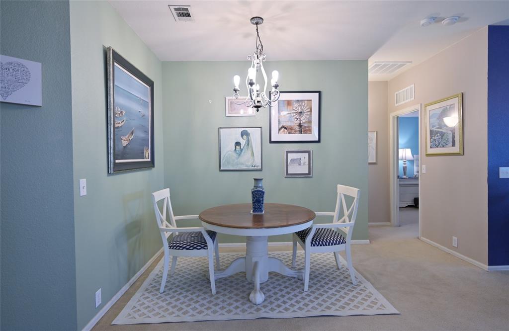 4509 Butterfly Way Fort Worth, TX 76244 - Photo 17 of 40 a dining room with furniture a rug and a chandelier