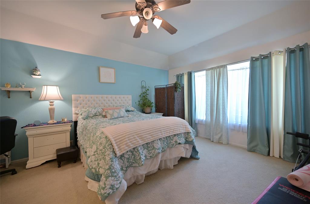4509 Butterfly Way Fort Worth, TX 76244 - Photo 18 of 40 a bedroom with a bed and a chandelier