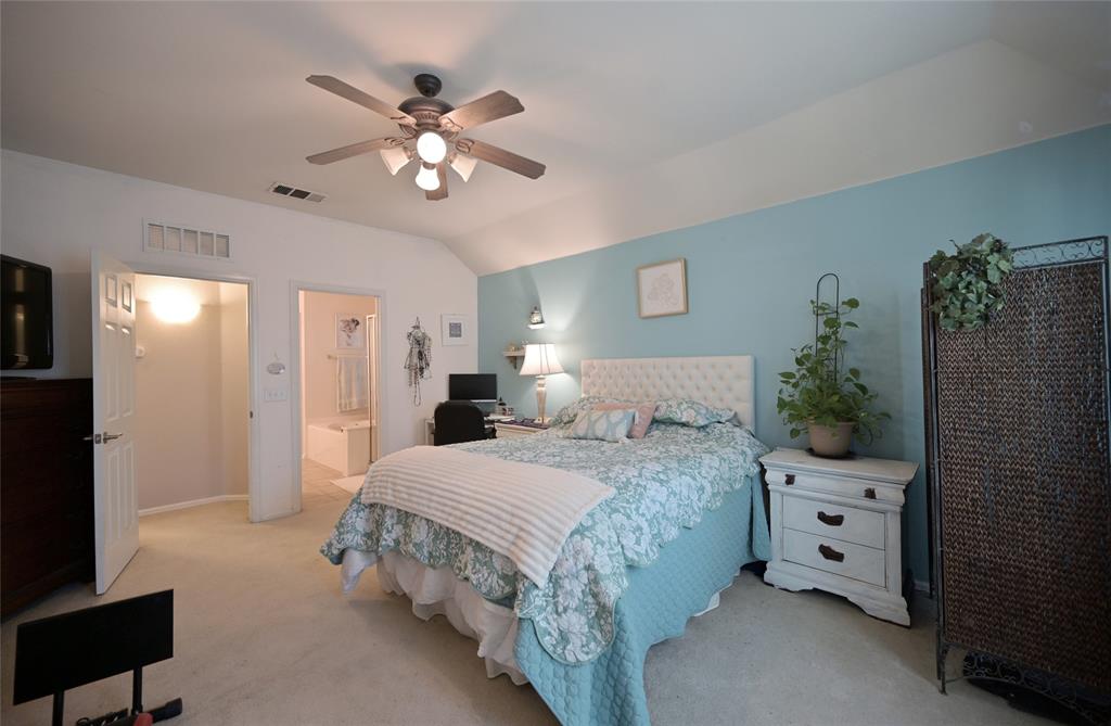 4509 Butterfly Way Fort Worth, TX 76244 - Photo 20 of 40 a bedroom with a large bed and a chandelier