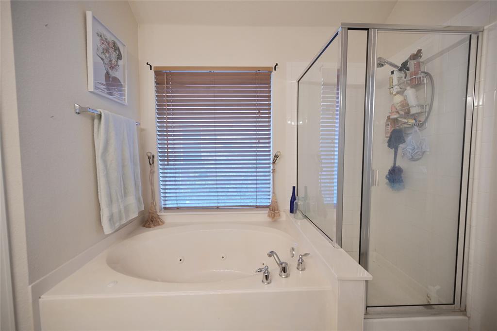 4509 Butterfly Way Fort Worth, TX 76244 - Photo 22 of 40 a bathroom with a bathtub and shower