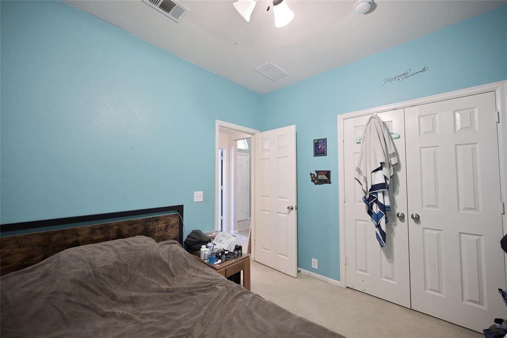 4509 Butterfly Way Fort Worth, TX 76244 - Photo 28 of 40 a bedroom with a large bed and a chandelier fan