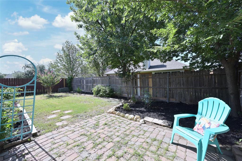 4509 Butterfly Way Fort Worth, TX 76244 - Photo 32 of 40 a view of a chair and table in backyard of the house