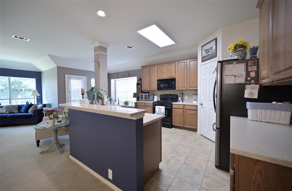 4509 Butterfly Way Fort Worth, TX 76244 - Photo 5 of 40 a kitchen with refrigerator and cabinets