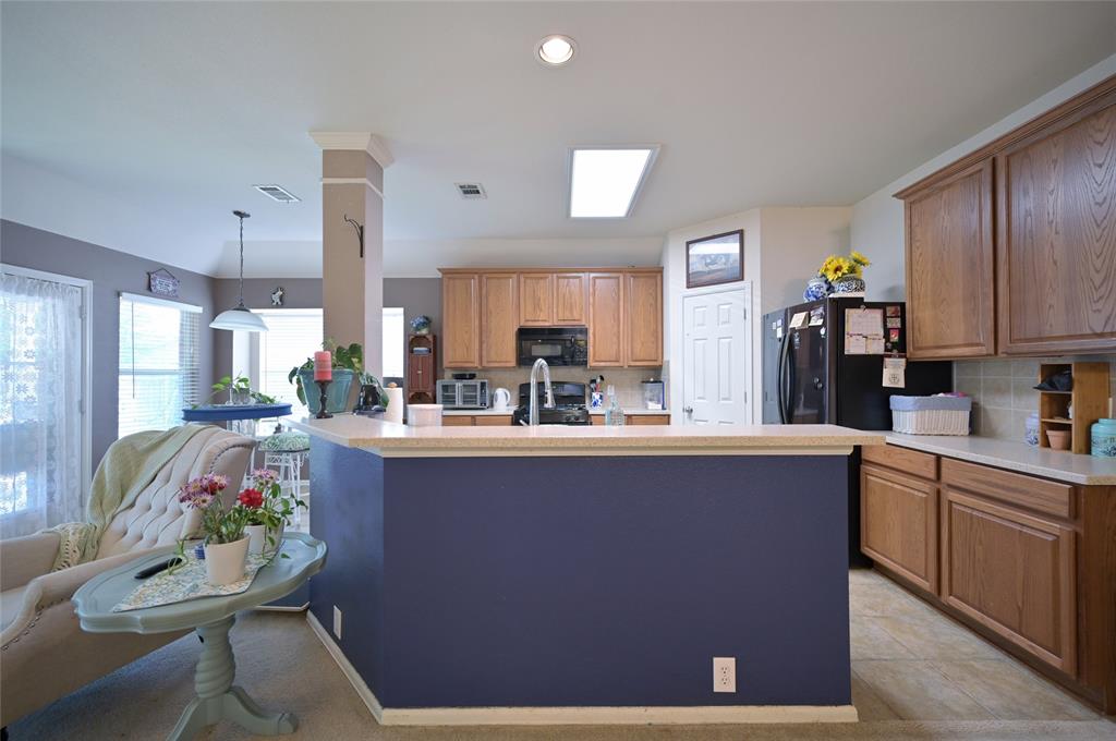 4509 Butterfly Way Fort Worth, TX 76244 - Photo 8 of 40 a kitchen with kitchen island stainless steel appliances a sink stove and cabinets