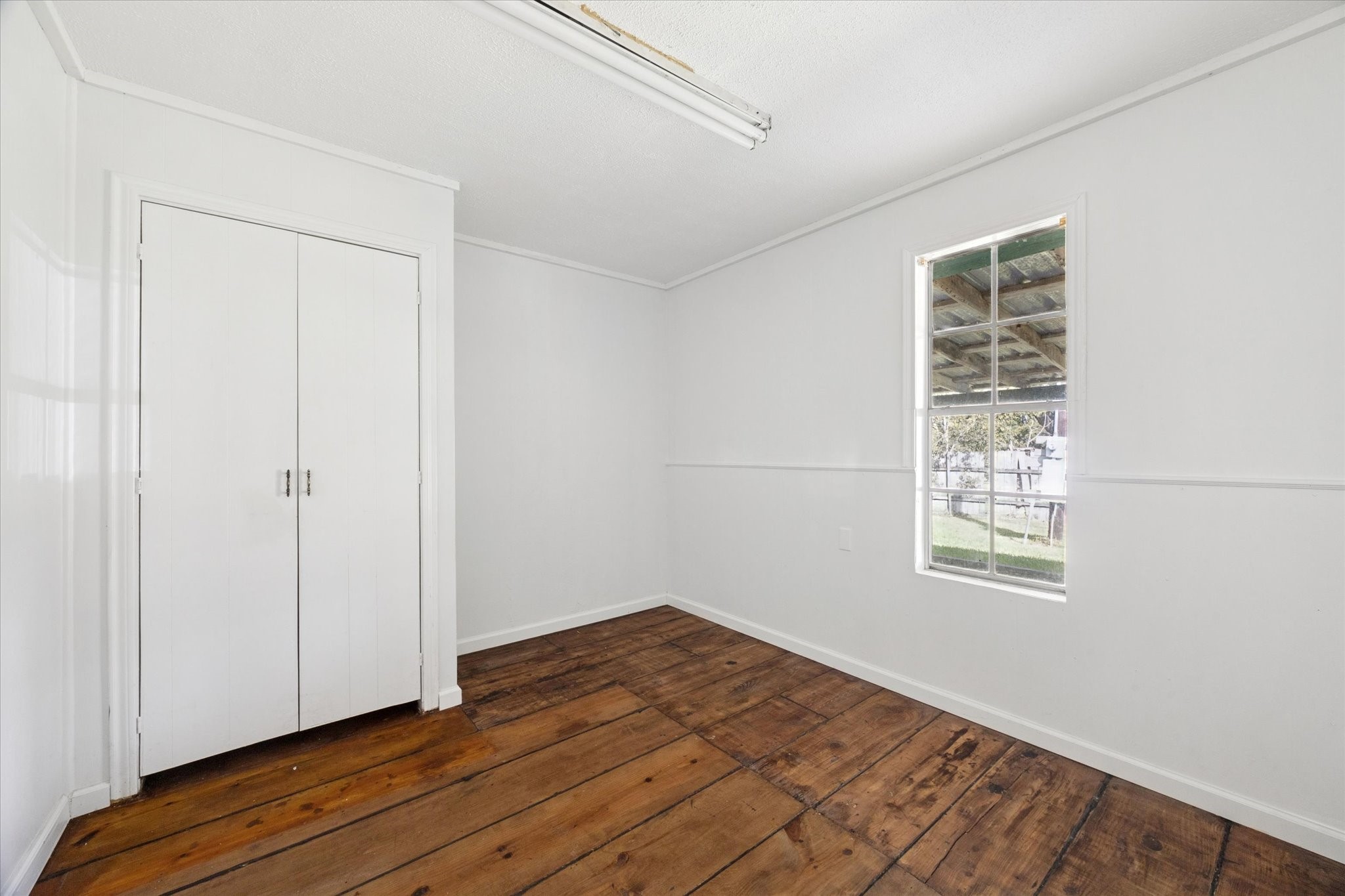 6219 Masters Manvel, TX 77578 - Photo 7 of 10 a view of an empty room with wooden floor and a window