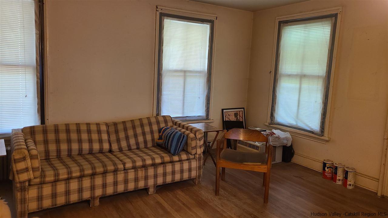 9 Dock Road Milton, NY 12547 - Photo 11 of 30 a blue couch sitting in a living room next to a window
