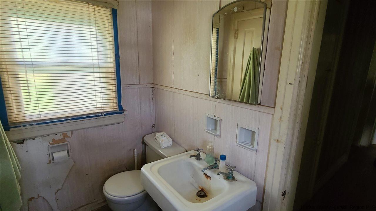 9 Dock Road Milton, NY 12547 - Photo 17 of 30 a bathroom with a sink a mirror and a toilet
