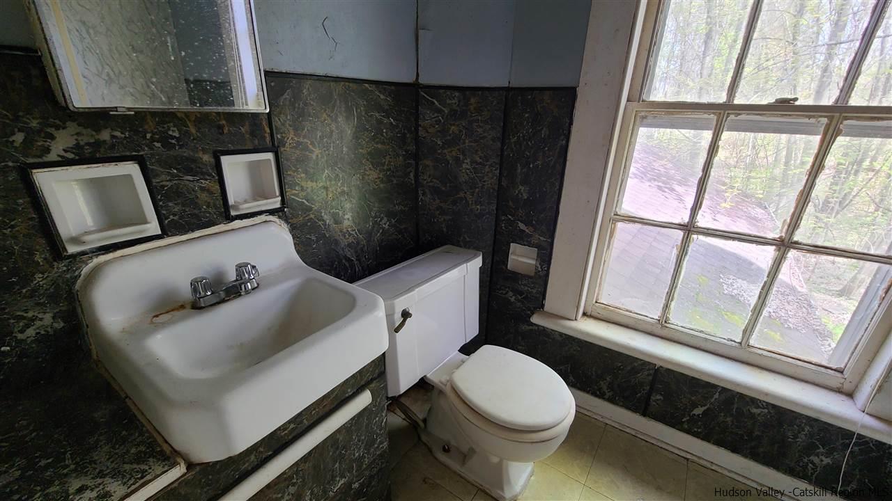 9 Dock Road Milton, NY 12547 - Photo 23 of 30 a white toilet sitting next to a bathroom sink