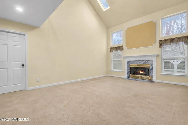 a view of an empty room with a fireplace