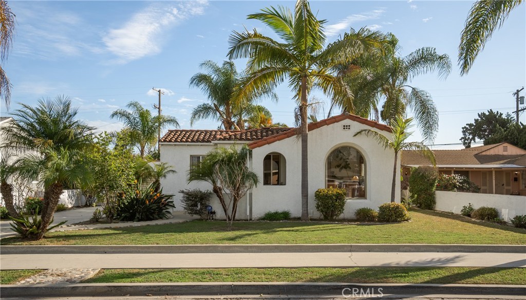 1502 East 57th Street Long Beach, CA 90805 - Photo 1 of 31 a front view of a house with a garden