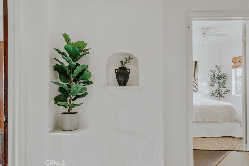 1502 East 57th Street Long Beach, CA 90805 - Photo 22 of 31 a white vase with white and yellow flowers