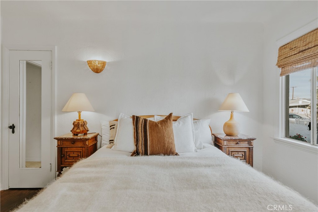 1502 East 57th Street Long Beach, CA 90805 - Photo 24 of 31 a bedroom with a bed and a lamp on table