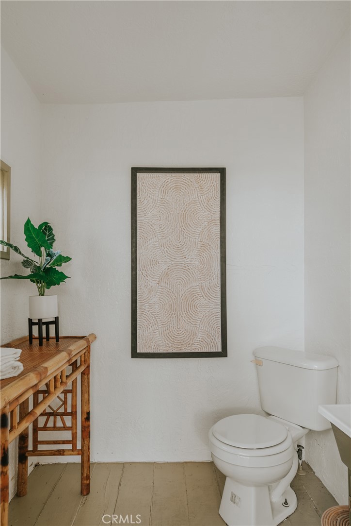 1502 East 57th Street Long Beach, CA 90805 - Photo 26 of 31 a bathroom with a toilet a sink and a mirror