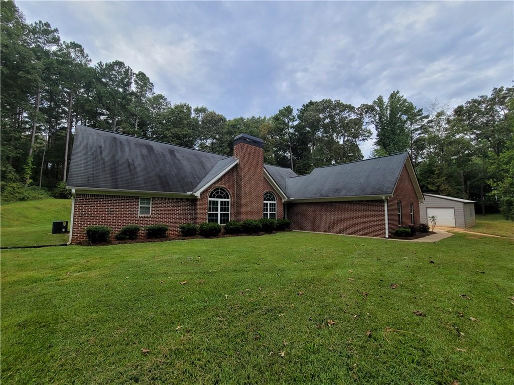 112 Moons Bridge Road Hoschton, GA 30548 - Photo 1 of 1 a house view with a garden space