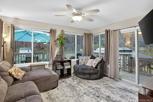 a living room with furniture and a large window with outer view