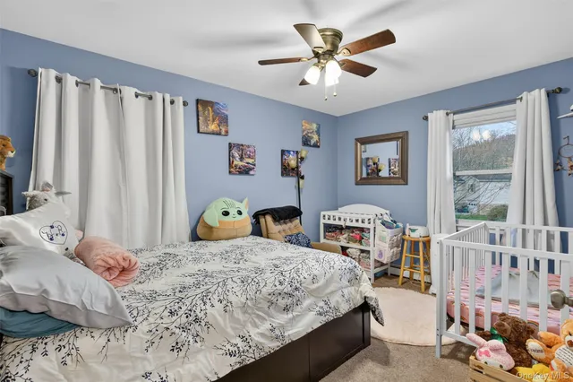 a bedroom that has a bed next to a window
