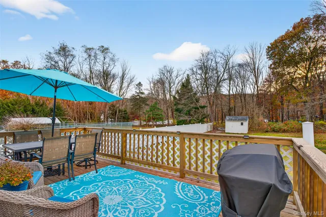 a view of a chairs and table under an umbrella
