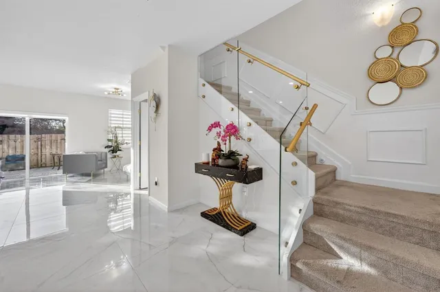 a view of hall way with furniture and flowers